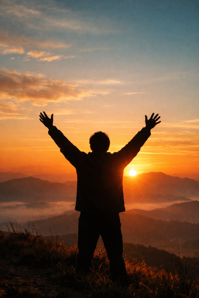 Person with raised arms in worship at sunrise symbolizing joy and hope despite difficult circumstances